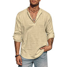 Man wearing a beige long-sleeve shirt and light blue jeans on a white background