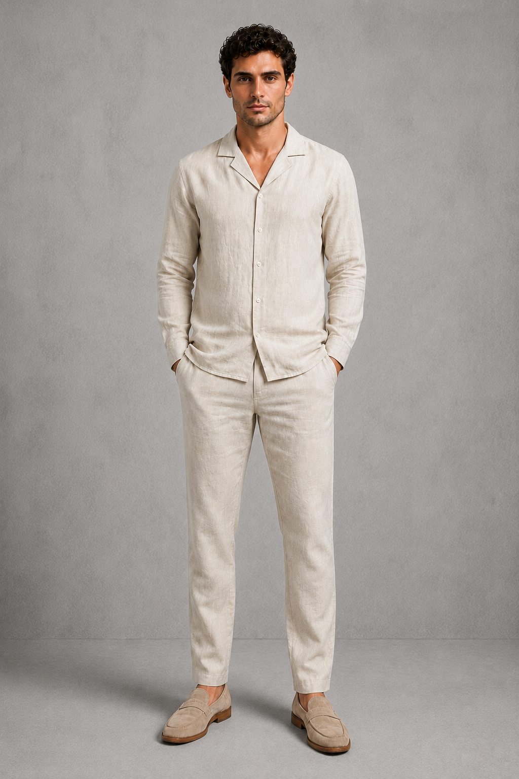 Man wearing a beige linen suit against a gray background