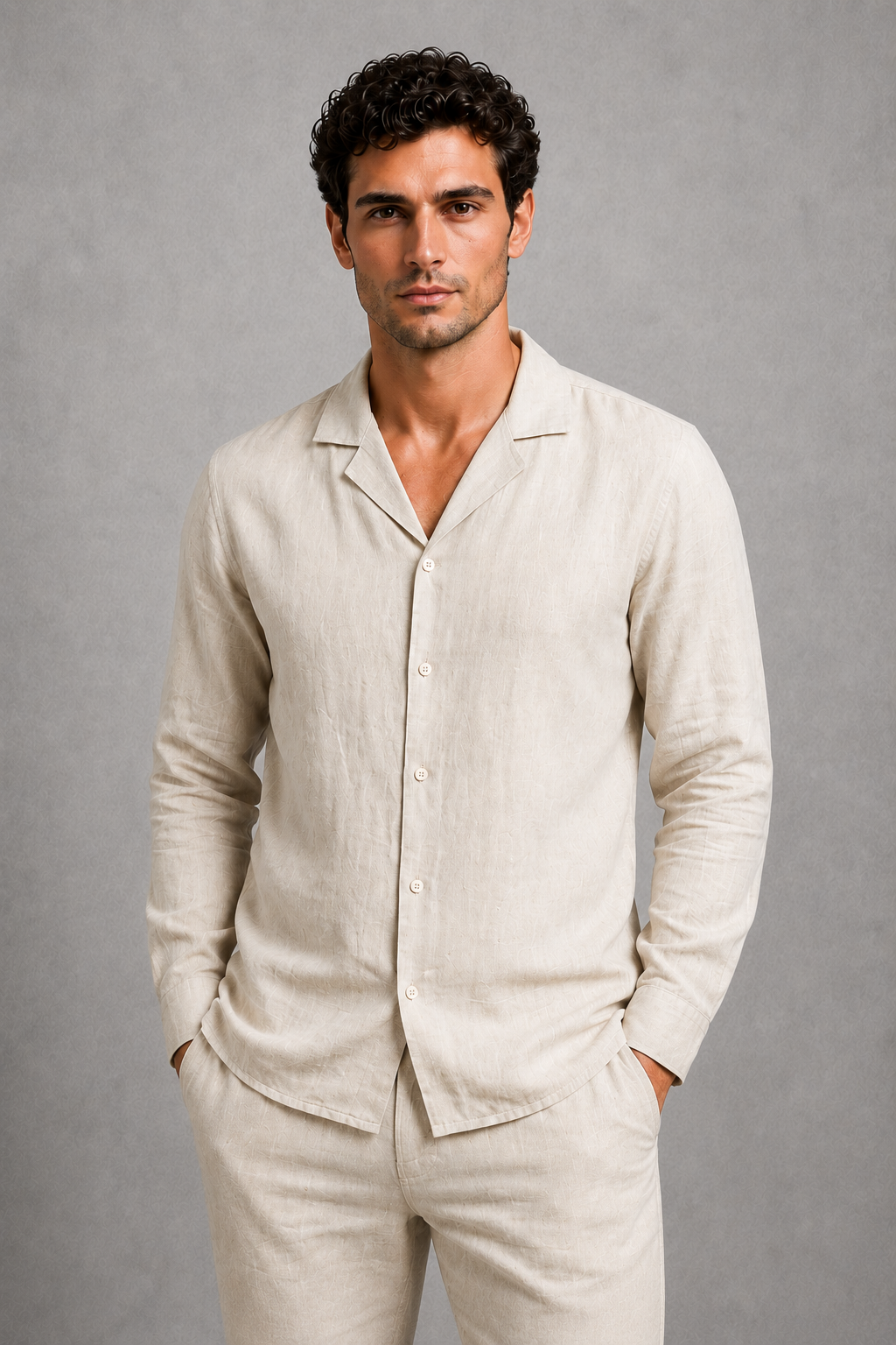 Man wearing a beige linen suit against a gray background