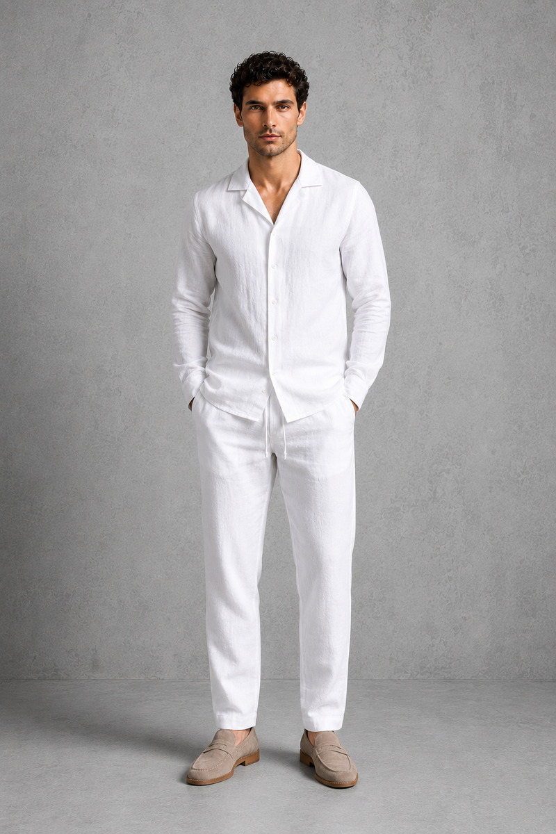 Man wearing a white linen suit against a gray background
