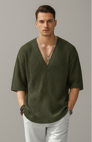 Person wearing a green sweater with a blurred background