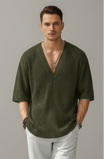 Person wearing a green sweater with a blurred background