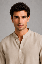 Man wearing a beige shirt against a gray background