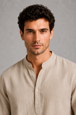 Man wearing a beige shirt against a gray background