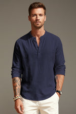 Man wearing a navy blue long-sleeve shirt with a white background