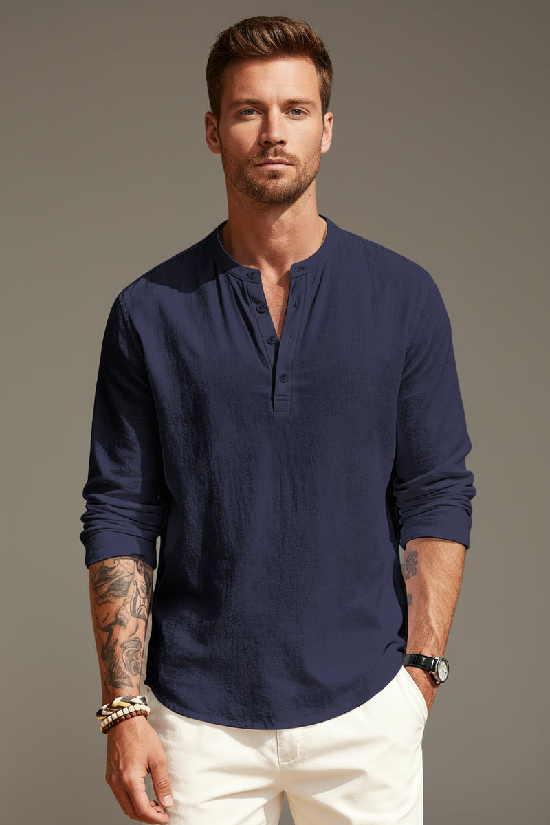 Man wearing a navy blue long-sleeve shirt with a white background