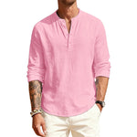 Man wearing a pink long-sleeve shirt and white pants on a white background