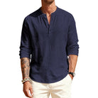 Man wearing a navy long-sleeve shirt with a brand logo on a white background