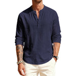 Man wearing a navy long-sleeve shirt with a brand logo on a white background