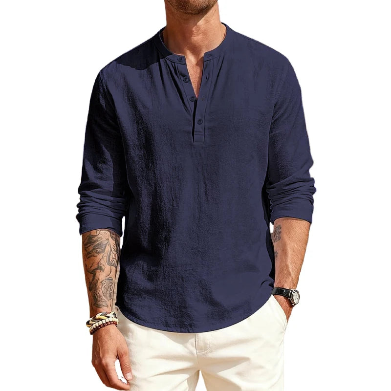 Man wearing a navy long-sleeve shirt with a brand logo on a white background