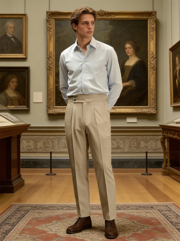 Man in a light blue shirt and beige pants standing in an art gallery.