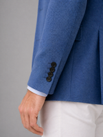 Blue blazer with white shirt and gray background