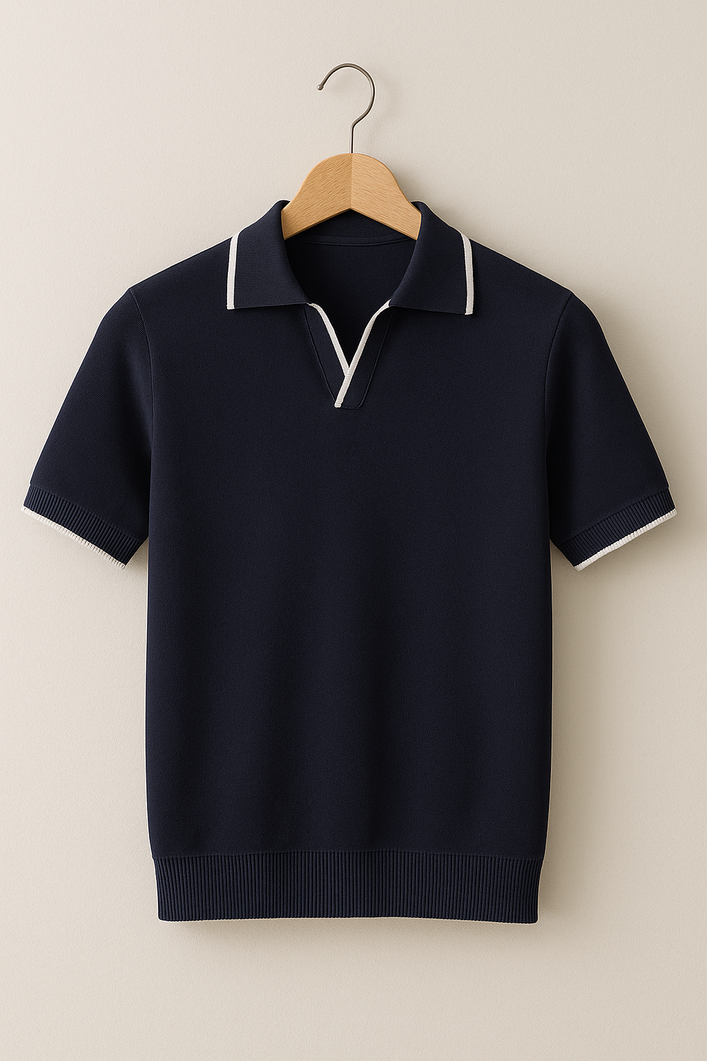 Navy short-sleeve sweater with white trim on a wooden hanger against a beige background
