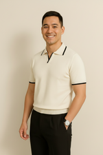 Man wearing a cream-colored polo shirt with black trim on a beige background