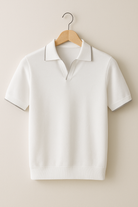 White polo shirt on a wooden hanger against a beige background