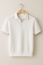 White polo shirt on a wooden hanger against a beige background