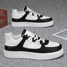 Black and white sneakers on a gray surface