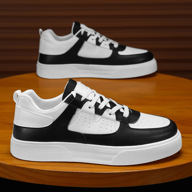 Black and white sneakers on a wooden surface