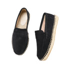 Pair of black espadrille loafers on a white background