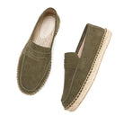 Pair of green suede espadrilles on a white background