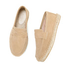 Pair of beige espadrille loafers on a white background