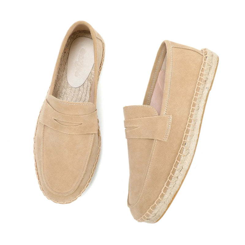 Pair of beige espadrille loafers on a white background