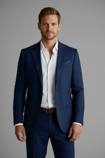 Man wearing a navy suit with a white shirt on a gray background