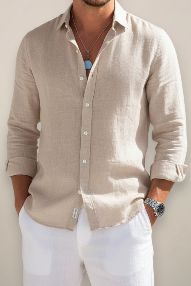 Man wearing a beige button-up shirt with a plain background