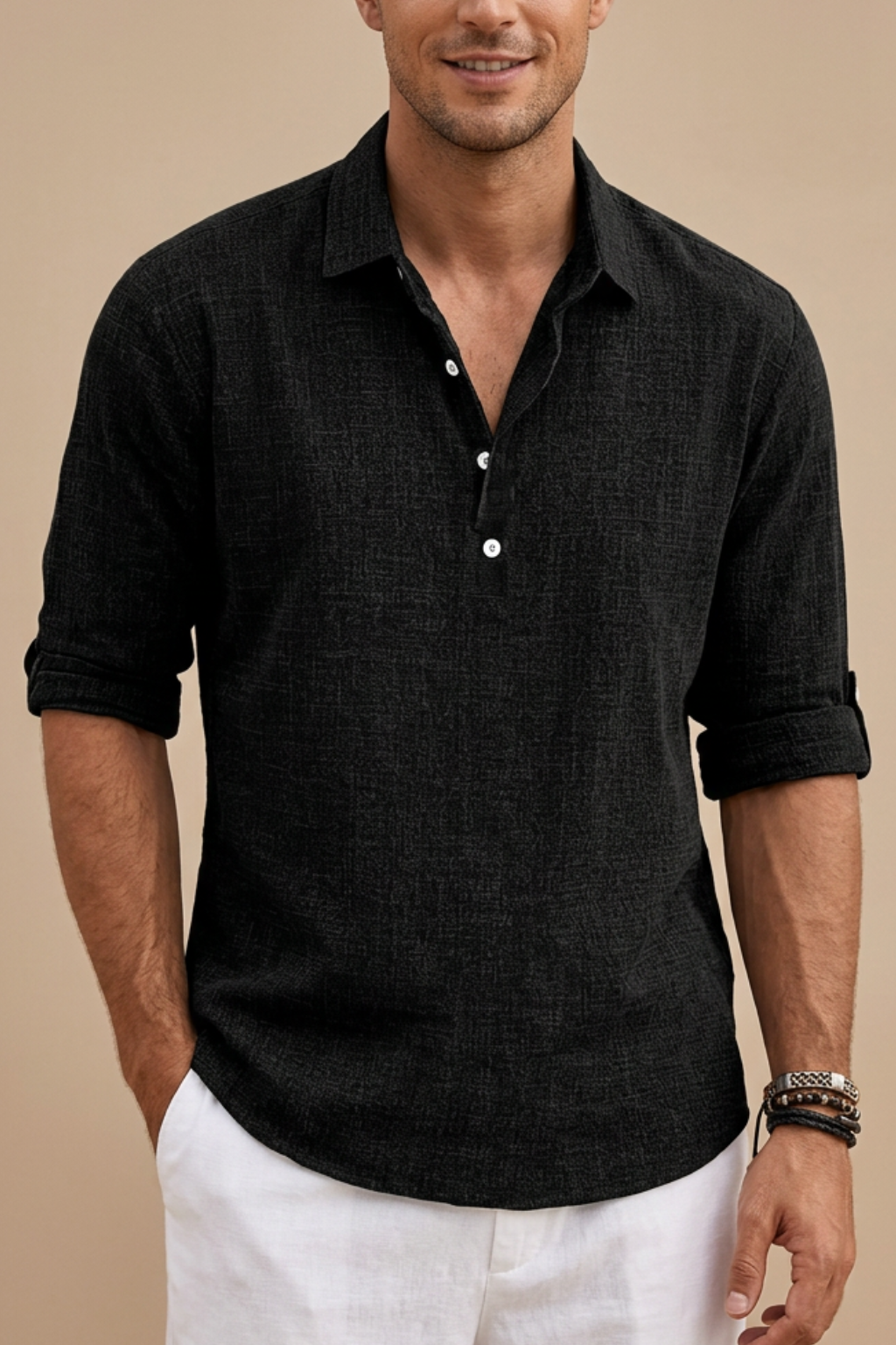 Man wearing a black short-sleeve shirt with rolled-up sleeves on a beige background