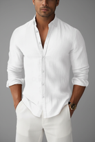 Man wearing a white button-up shirt against a beige background