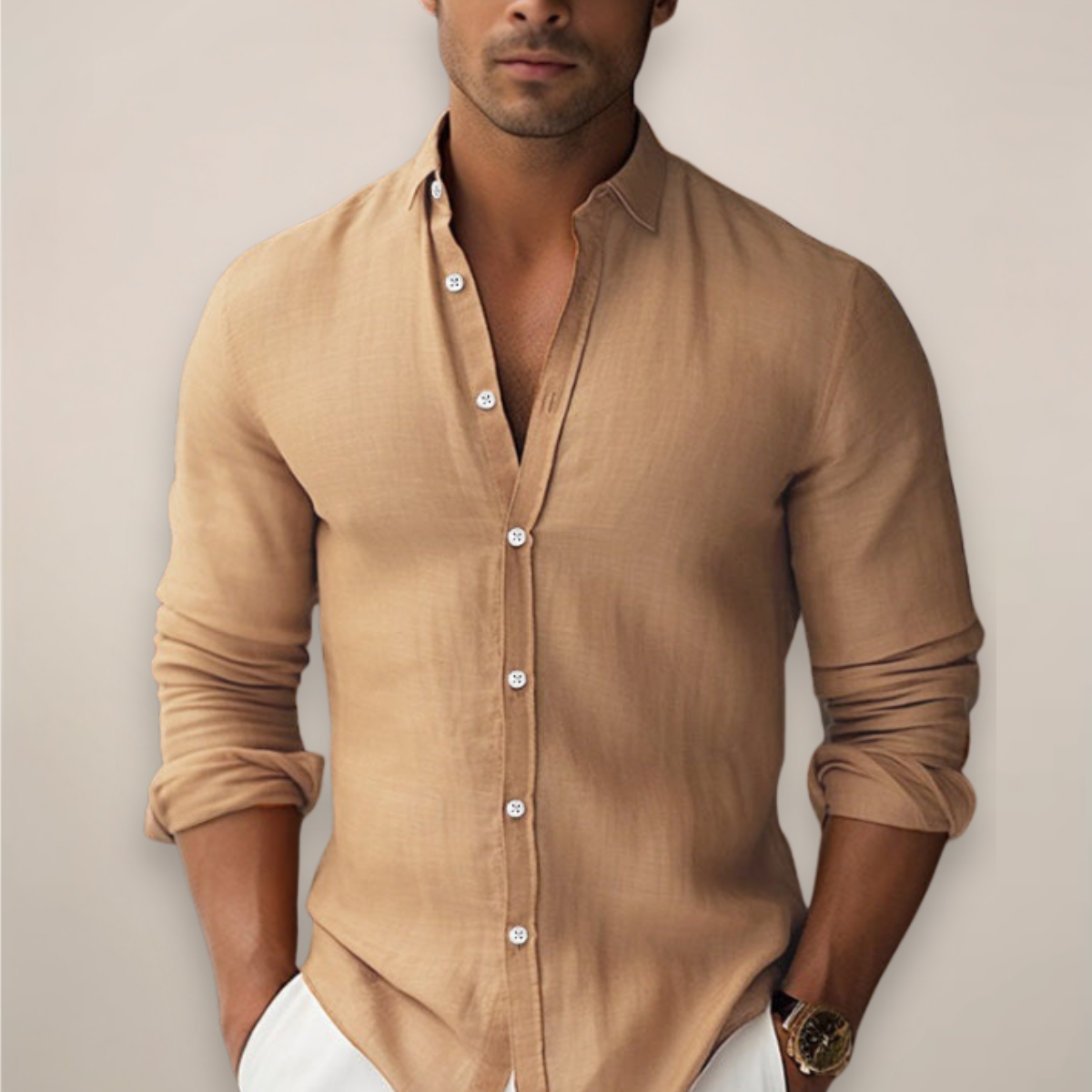 Man wearing a beige button-up shirt against a plain background