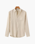 Beige shirt on a hanger against a white background