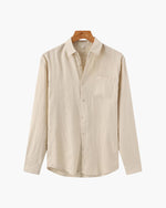 Beige shirt on a hanger against a white background