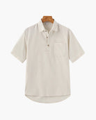 Beige short-sleeve shirt on a wooden hanger against a white background