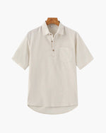 Beige short-sleeve shirt on a wooden hanger against a white background