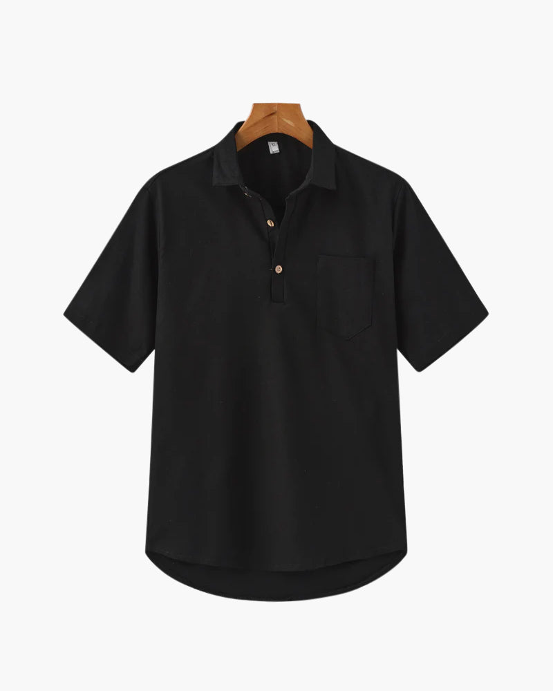 Black short-sleeve shirt on a hanger against a white background