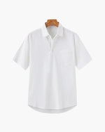 White shirt on a wooden hanger against a white background