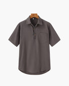 Gray short-sleeve shirt on a hanger with a white background