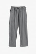 Gray pants on a wooden hanger against a white background
