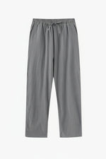 Gray pants on a wooden hanger against a white background