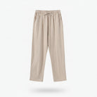 Beige pants on a hanger against a white background