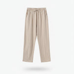 Beige pants on a hanger against a white background