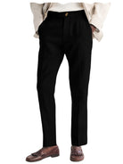 Black dress pants worn with a beige blazer and brown shoes on a white background
