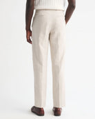 Person wearing beige dress pants on a white background