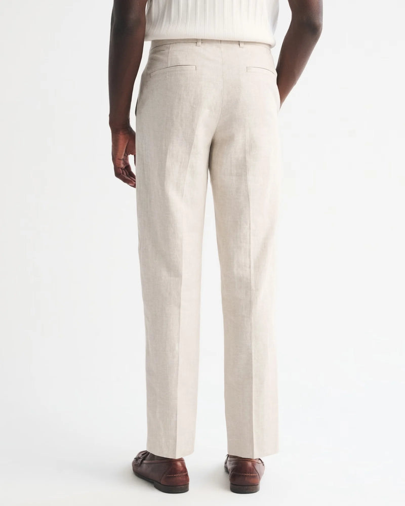Person wearing beige dress pants on a white background