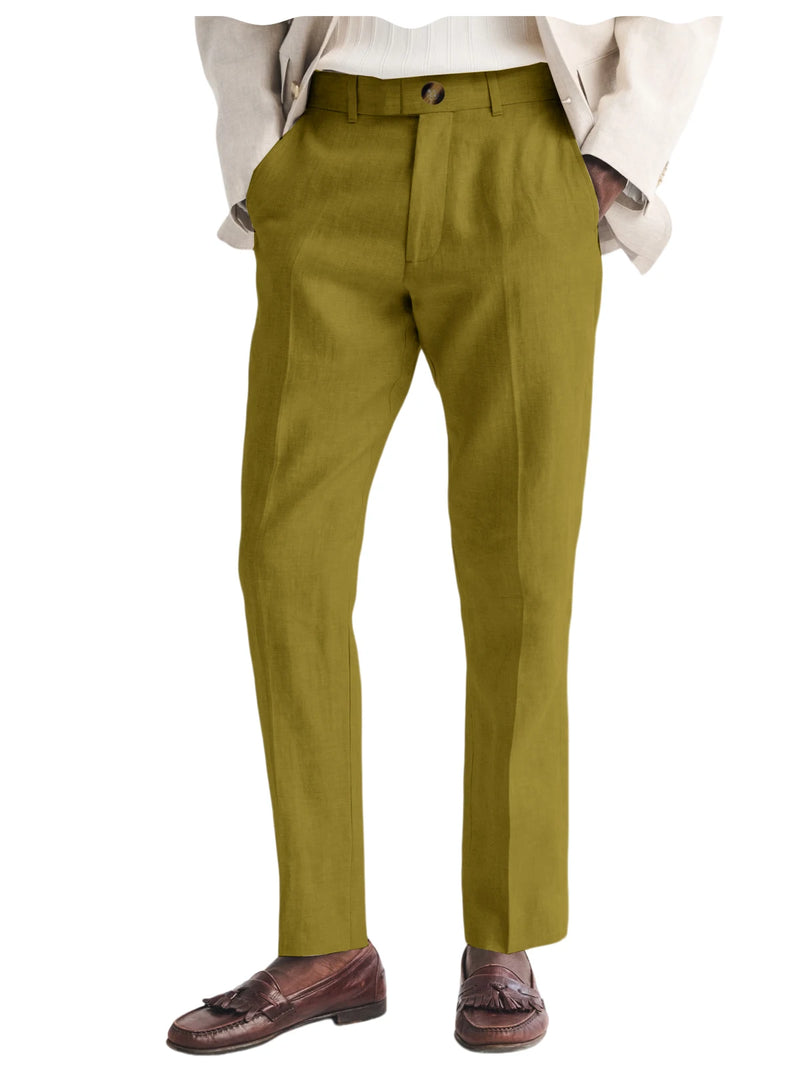 Green dress pants worn with a white shirt and brown shoes on a white background