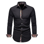 Black shirt with floral patterns on collar and cuffs against a white background