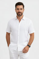 Man wearing a white short-sleeve shirt on a light gray background