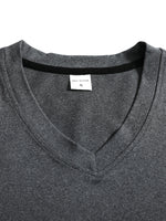 Close-up of a gray shirt with a brand label on a white background