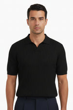 Person wearing a black short-sleeve shirt and dark pants on a white background